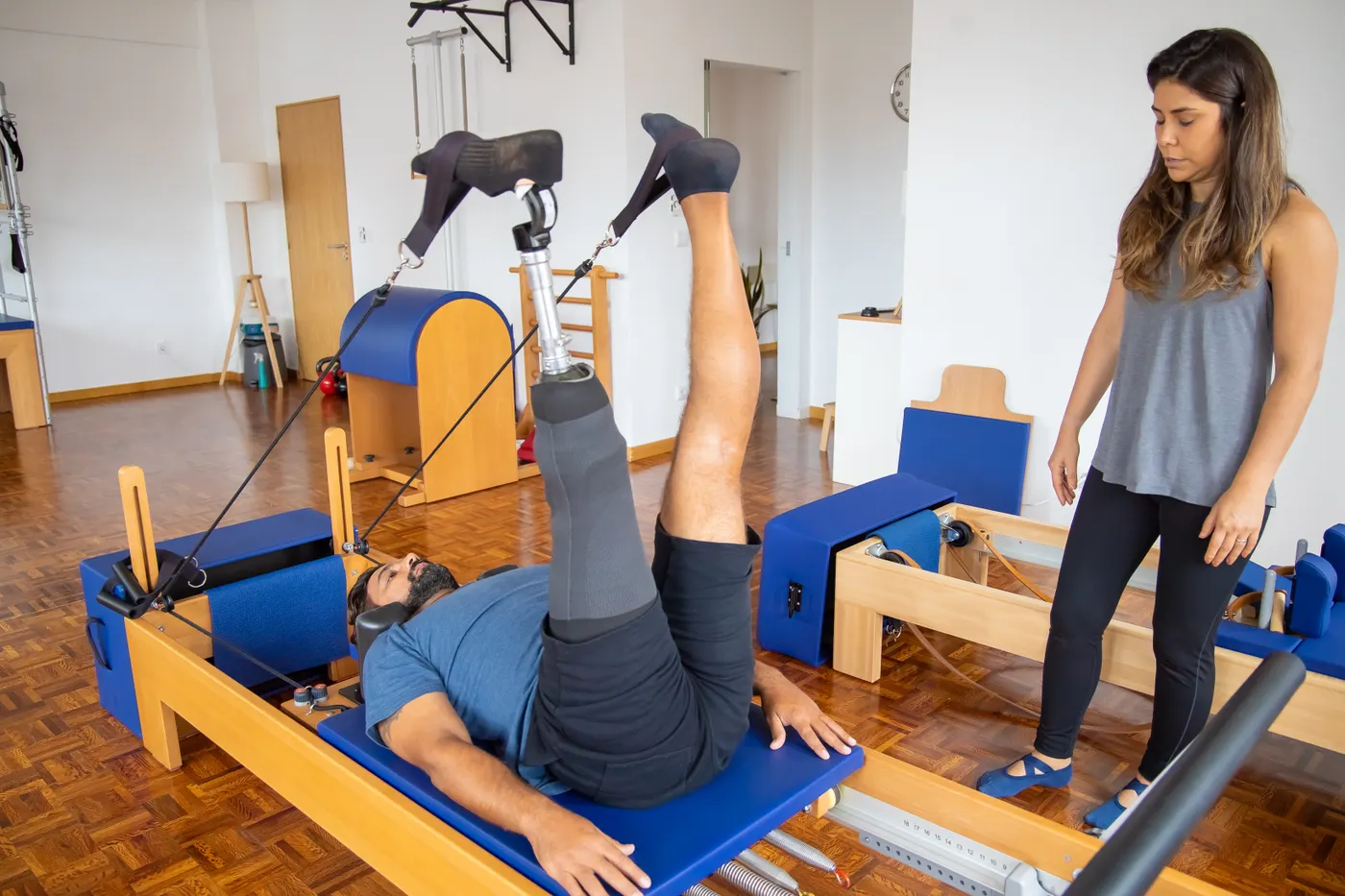Patient with a prosthetic leg practicing rehabilitation exercise