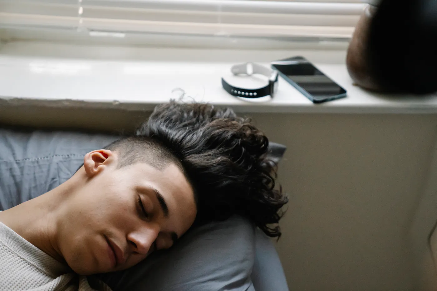 Man sleeping in a bedroom, representing overnight recovery