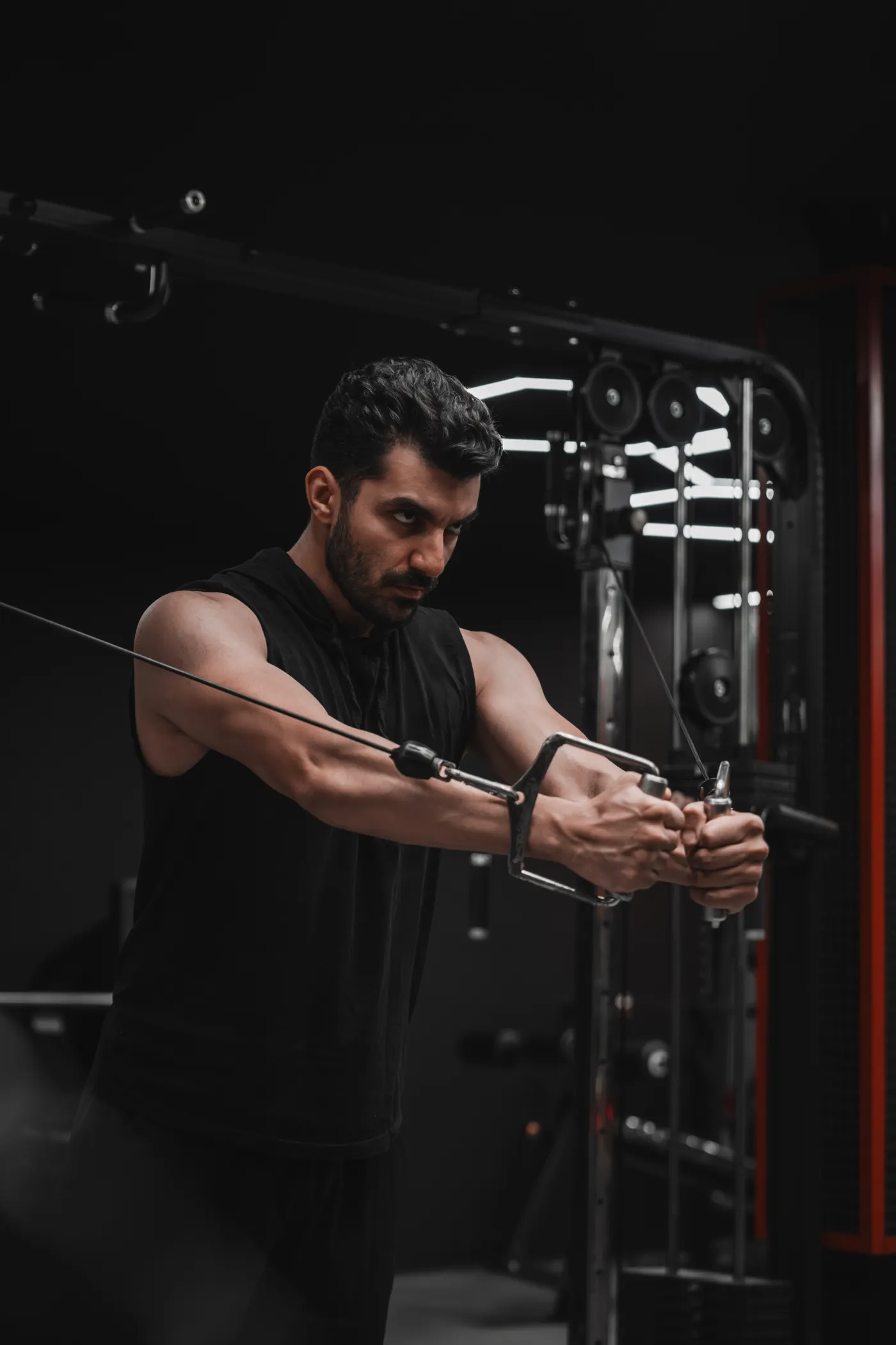 Man training at a cable machine in a gym