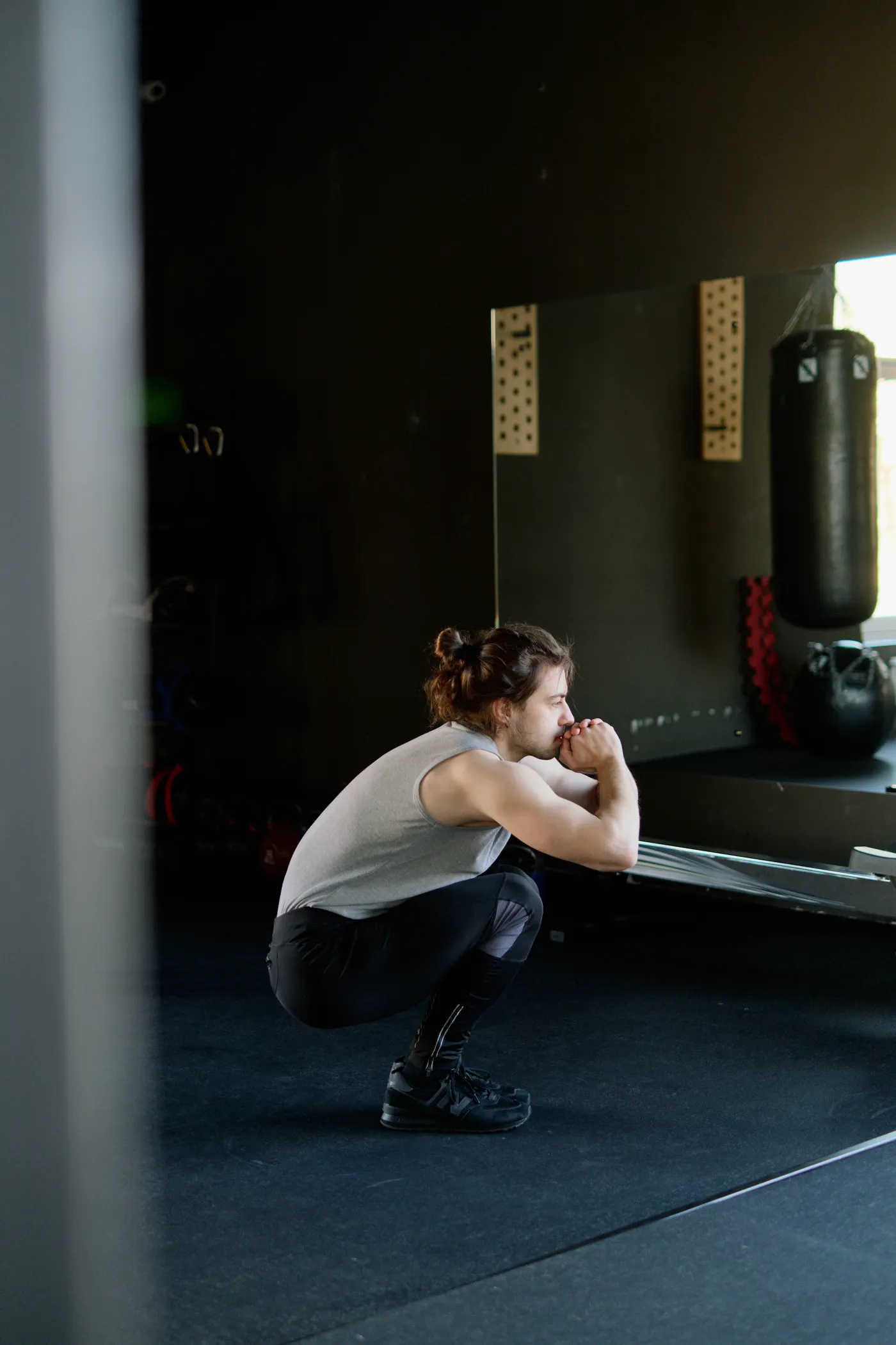 Man practicing squats in a gym