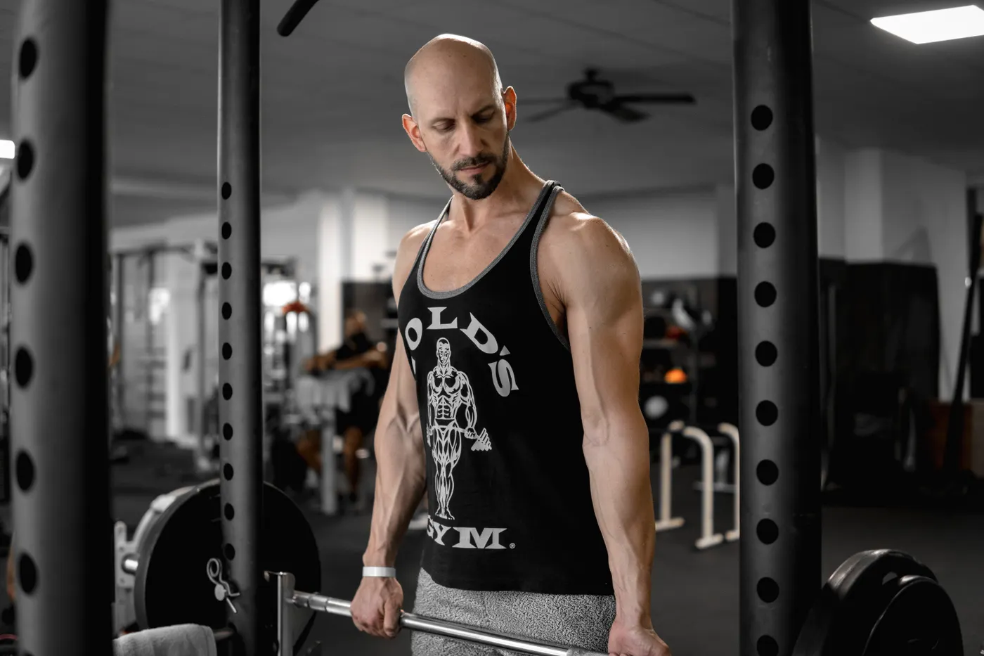 Man training with a loaded barbell in a modern gym