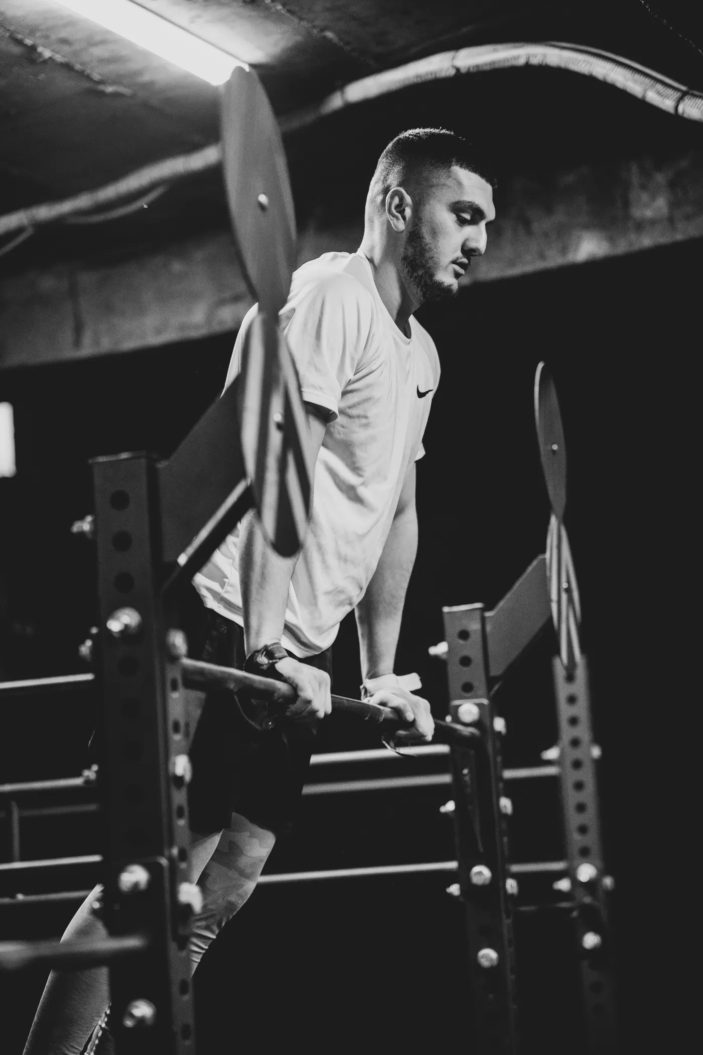 Man training on parallel bars in an indoor gym