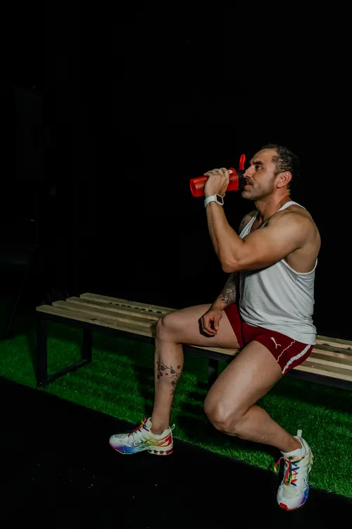 Athlete seated on a bench taking a short recovery break