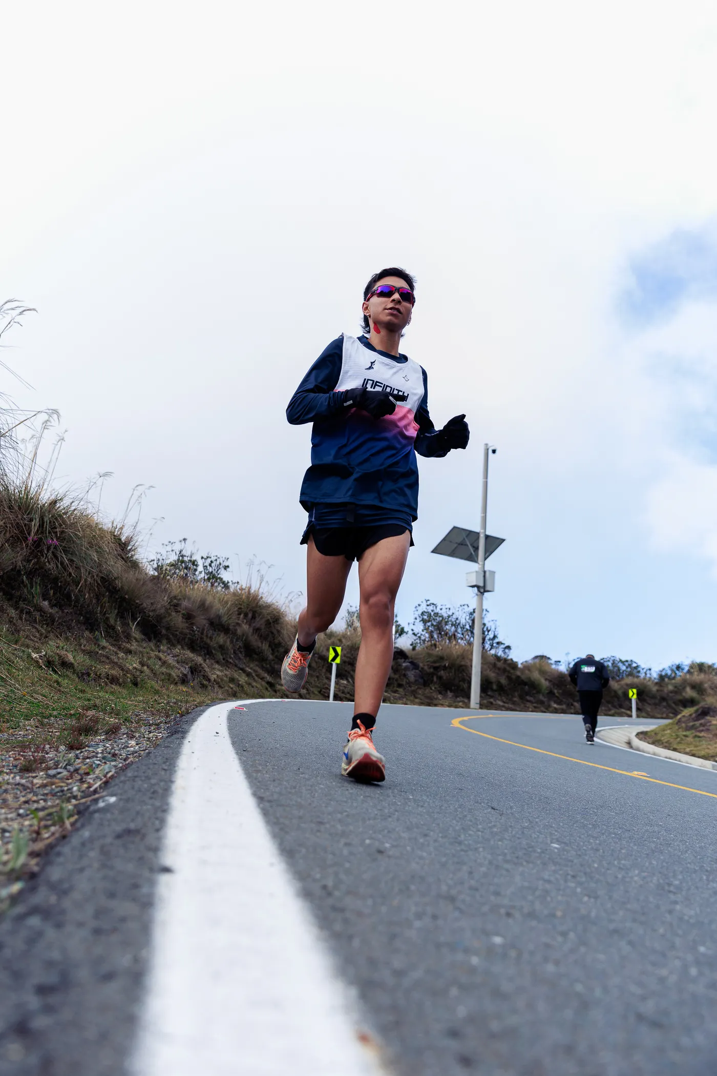 Marathon runner training on a winding outdoor road