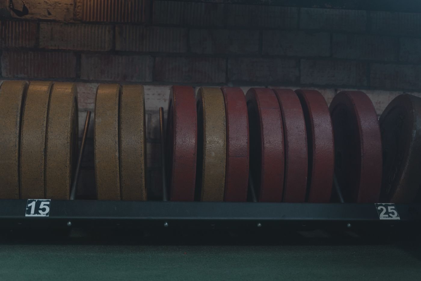 Weight plates arranged in a gym for progressive loading