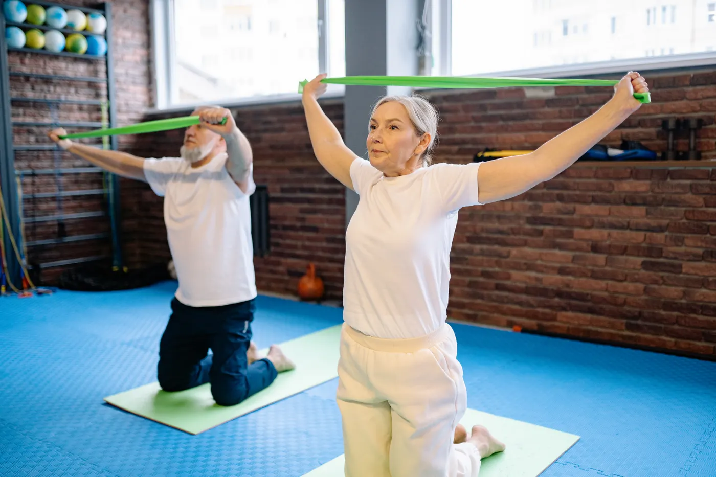 Older adults using resistance bands during a supervised fitness session
