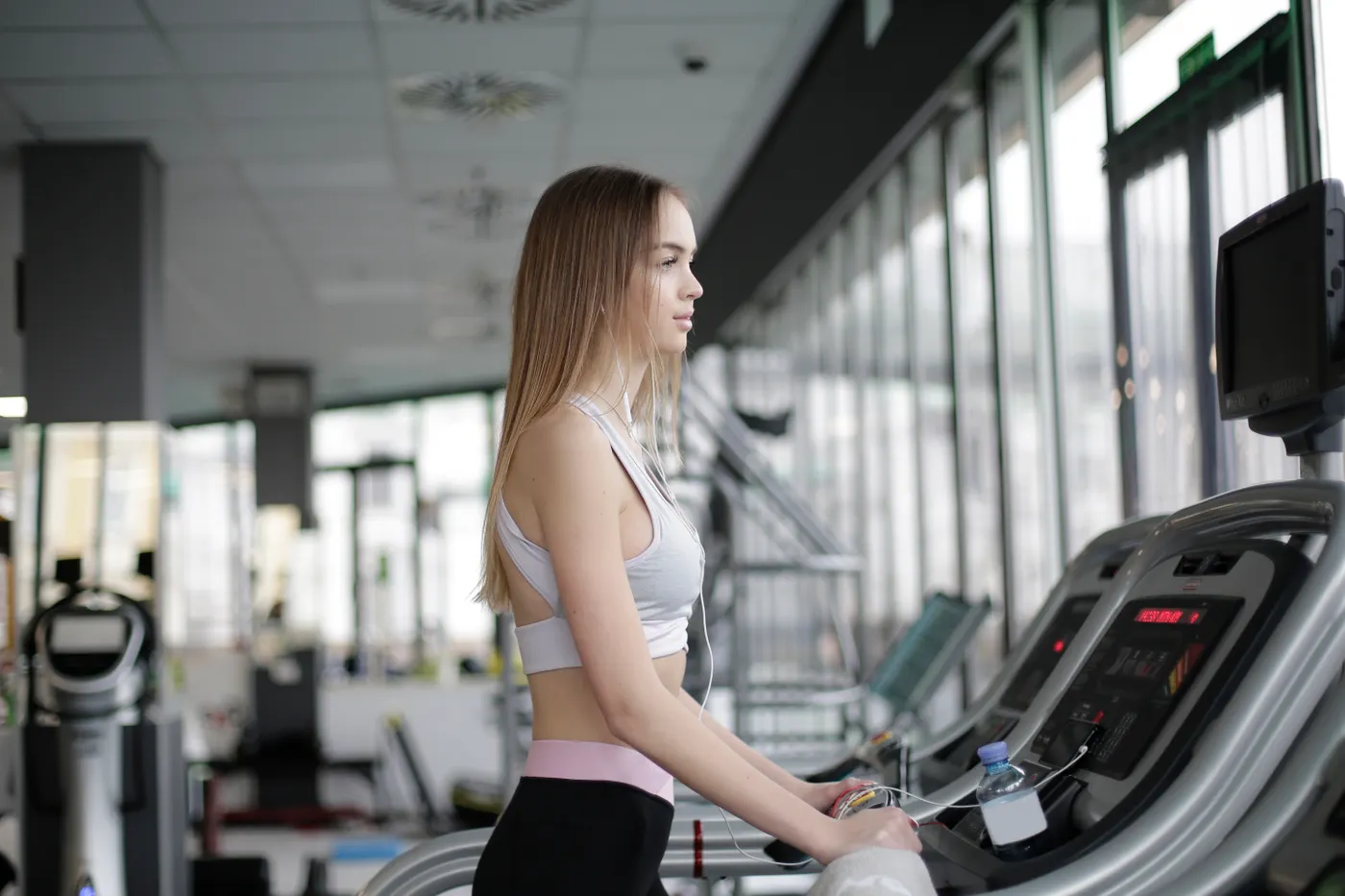 Athlete checking a phone during treadmill training