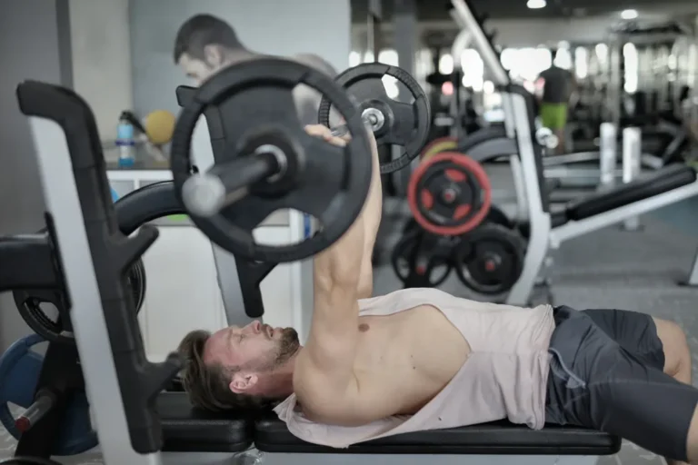 Athlete pressing a barbell during a controlled gym workout