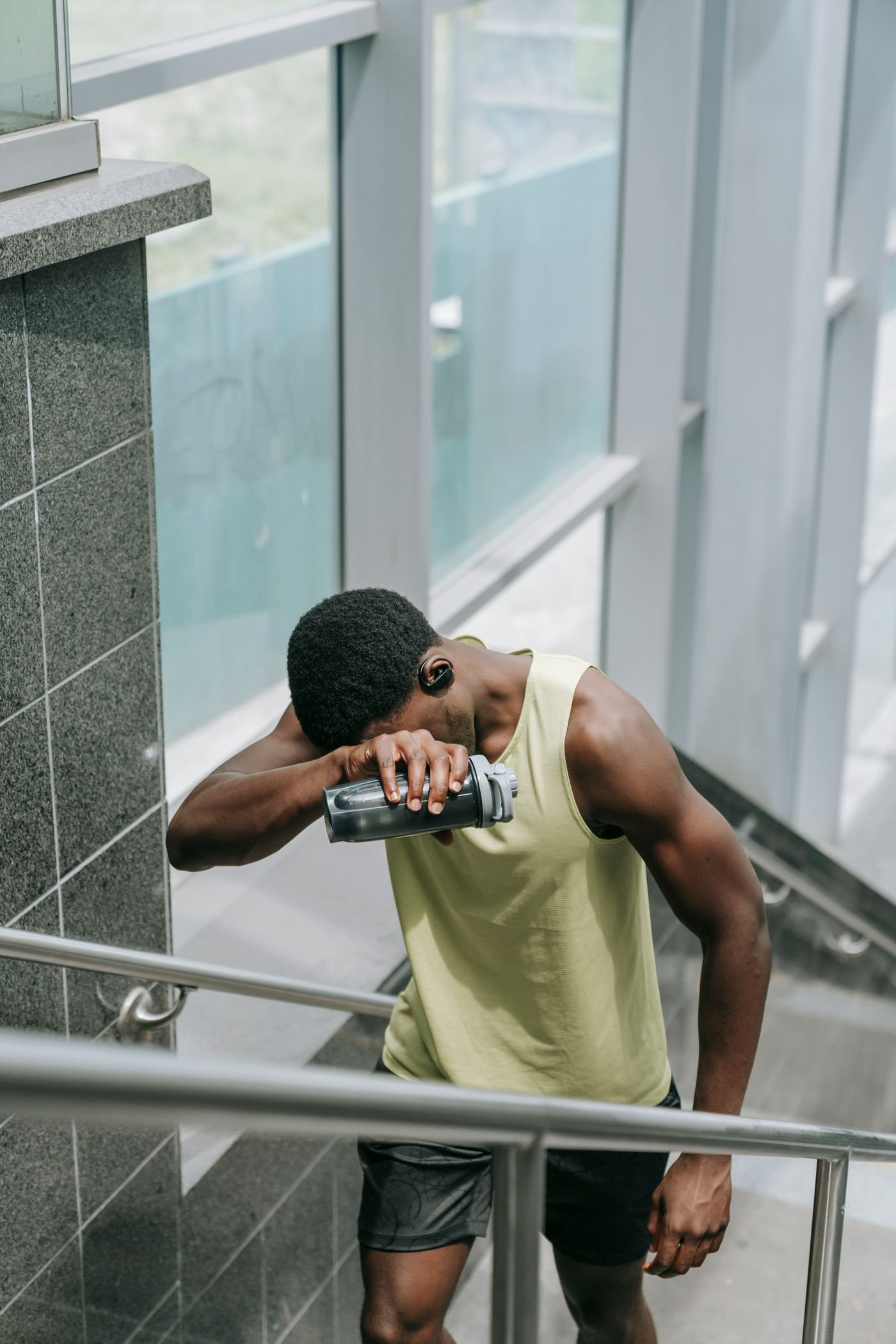 Tired runner pausing on outdoor steps after exercise
