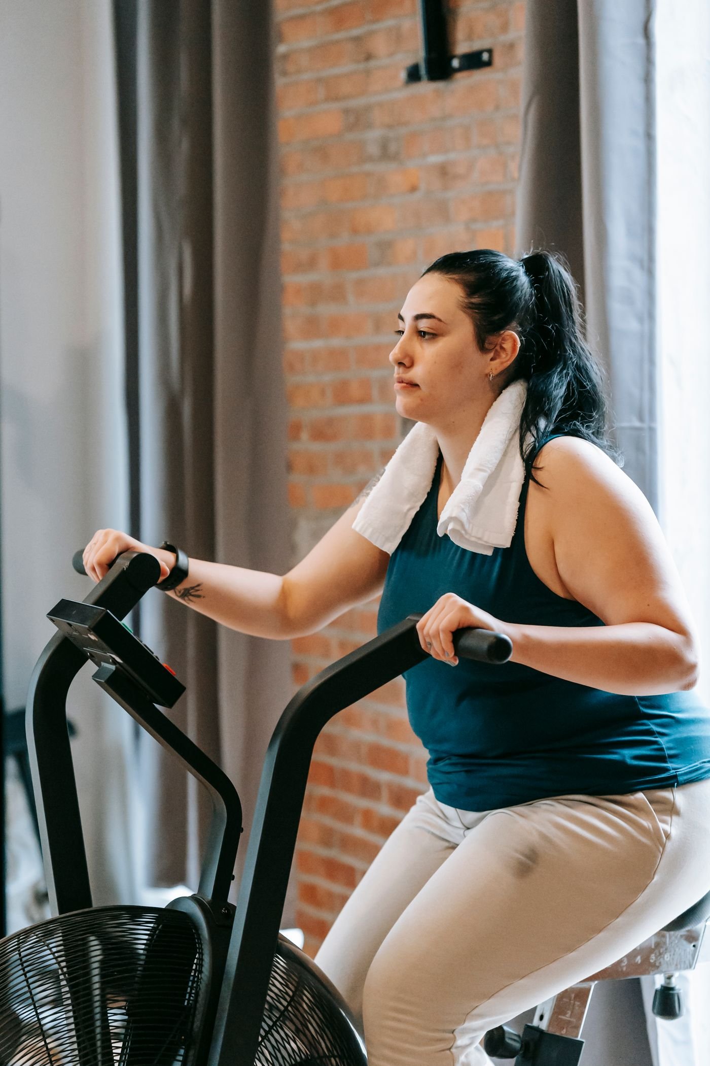 Woman exercising on a stationary bicycle during a cardio workout