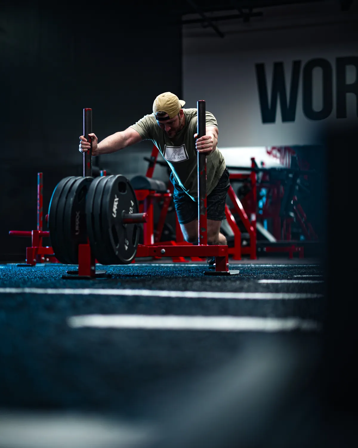 Athlete pushing a weighted sled during a hard conditioning effort