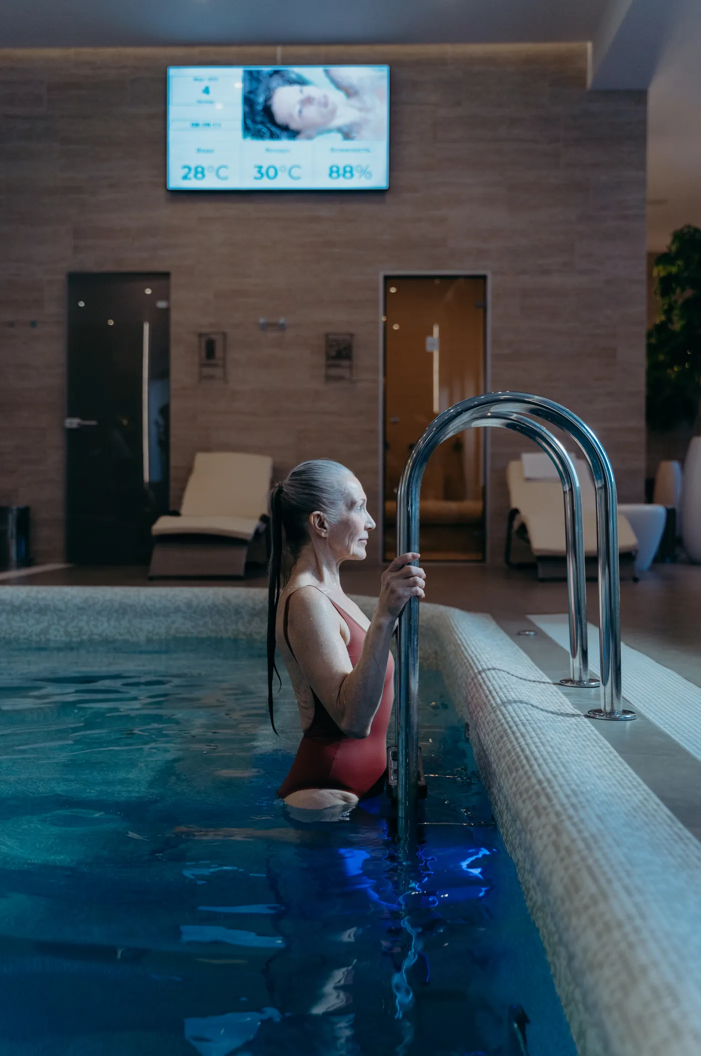 Older woman moving through water in an indoor pool