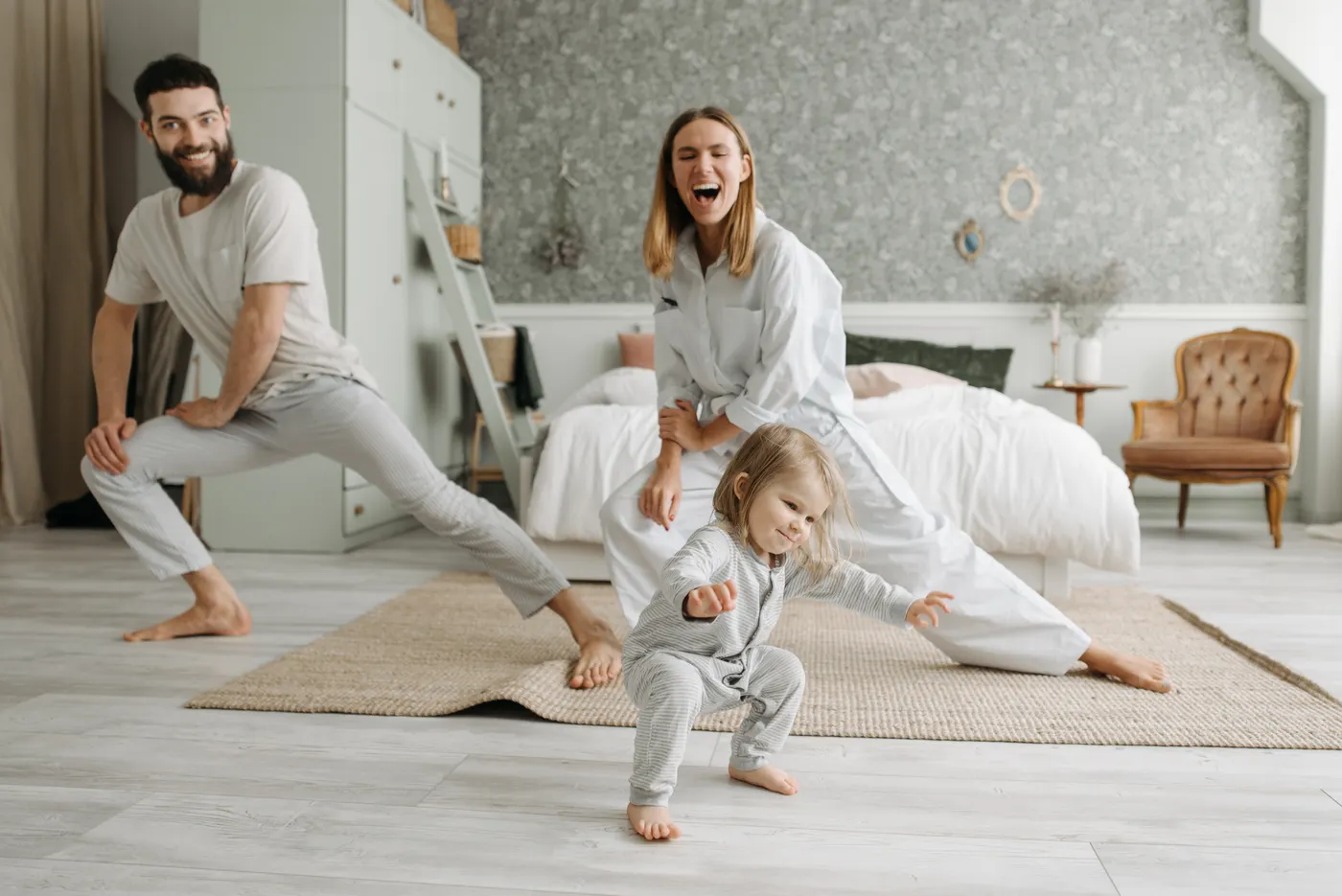 Parents stretching together with their young daughter