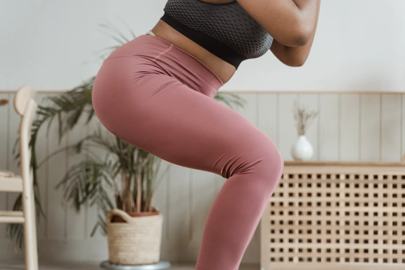Woman performing a squat indoors