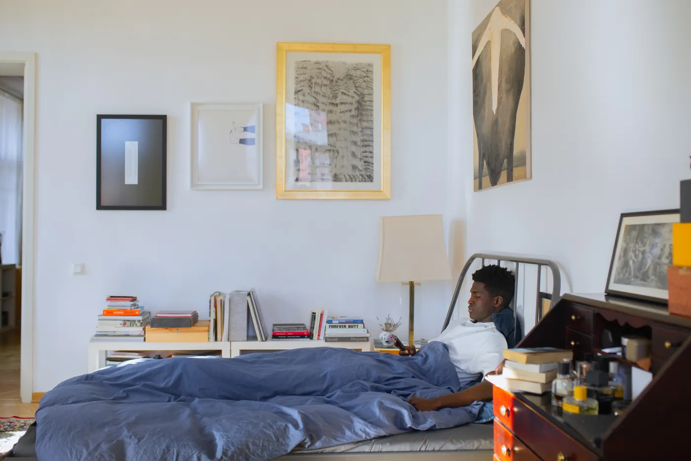 Man resting on a bed in a quiet room