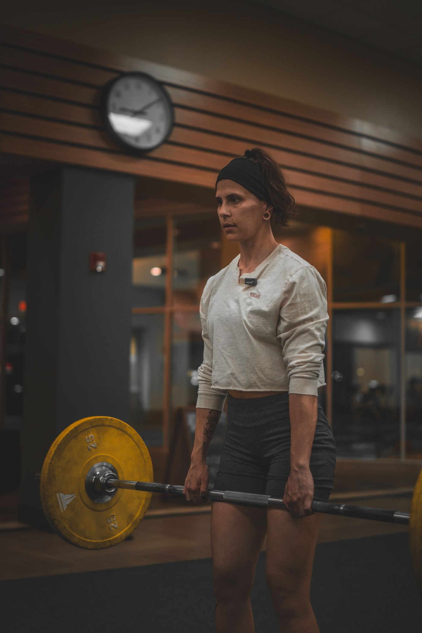 Woman performing a barbell deadlift in a gym