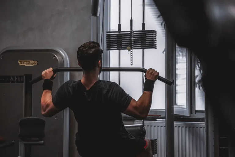 Rear view of a man performing a lat pulldown at a cable machine