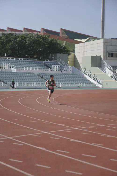 Runner training on an outdoor athletics track