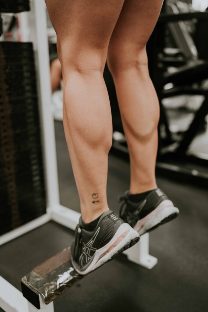 Close-up of a woman performing calf raises at a gym