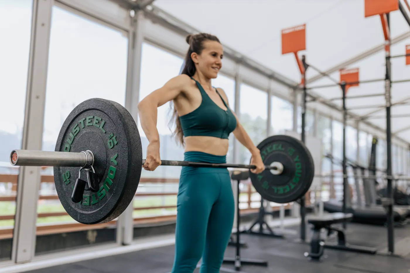 Woman lifting a barbell during a controlled strength session