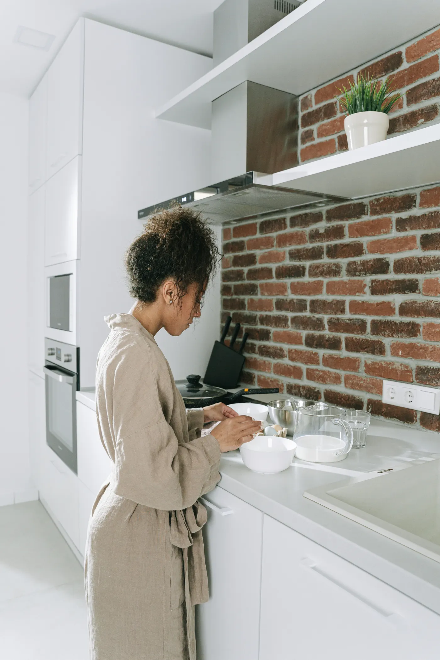 Woman preparing a meal in a bright kitchen