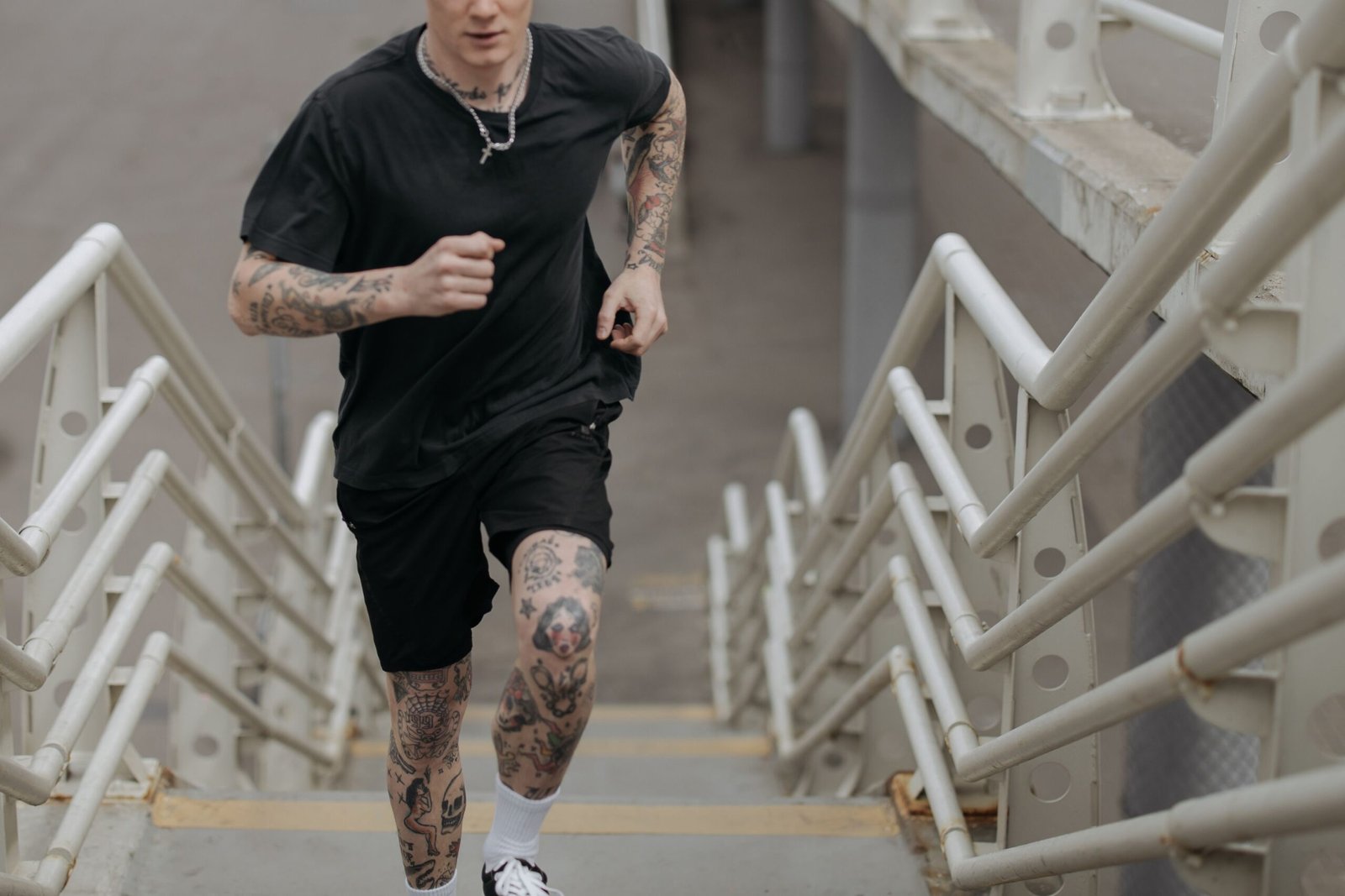 Man running up a concrete staircase for a brief vigorous cardio effort
