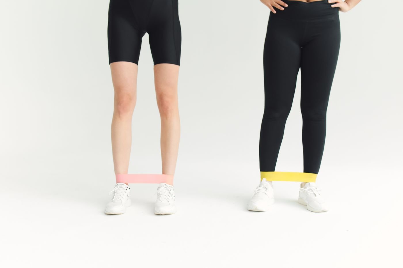 Two women training with resistance bands in a fitness session
