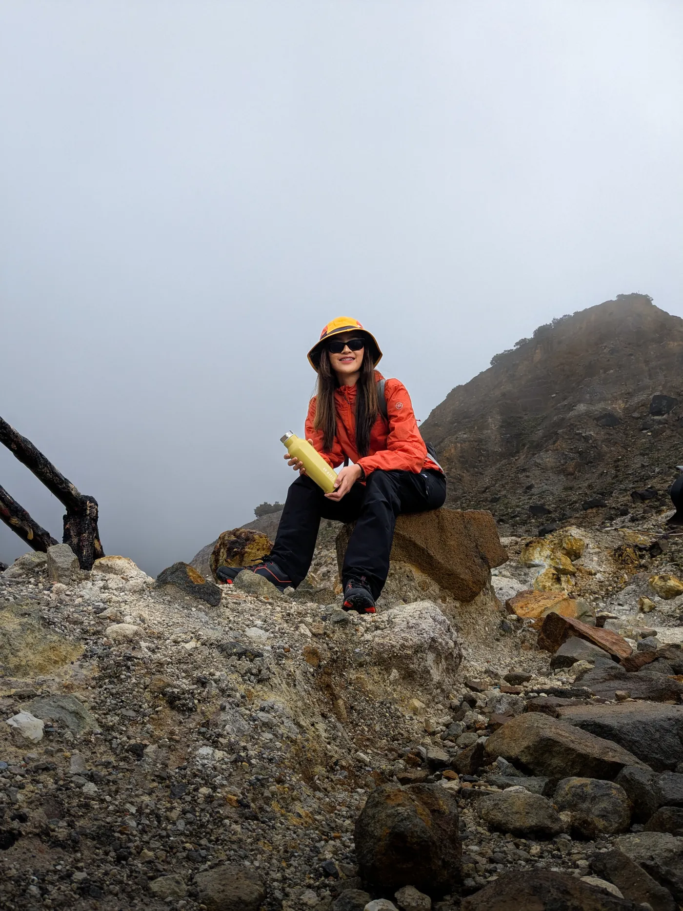 Hiker resting on a rocky mountain trail