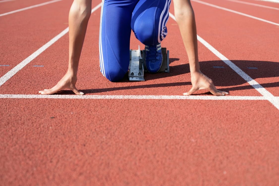 Sprinter preparing at the starting blocks on a track