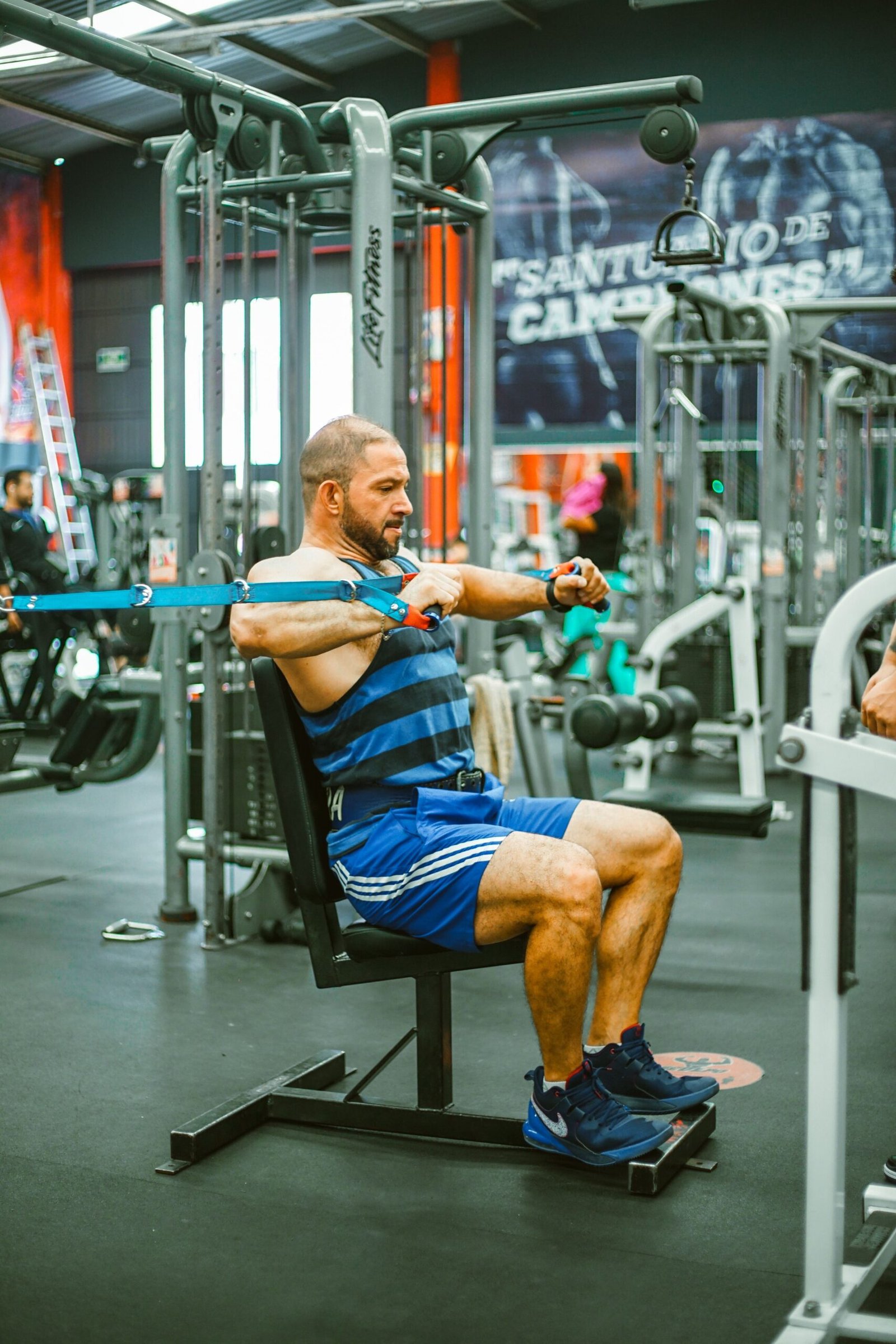 Man training with resistance bands in a gym