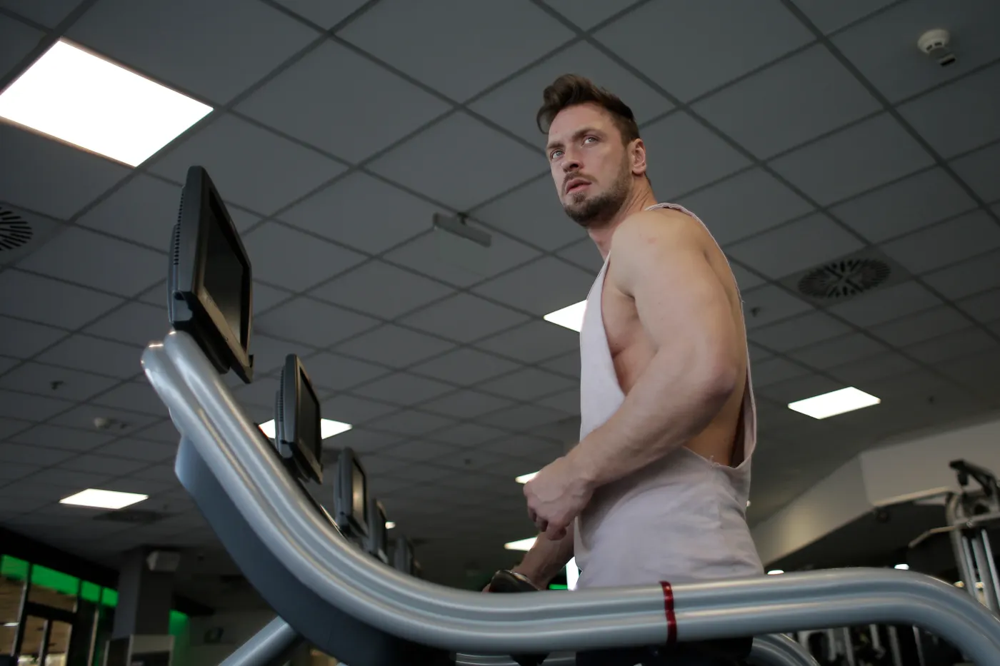 Male athlete running on a treadmill in a fitness center