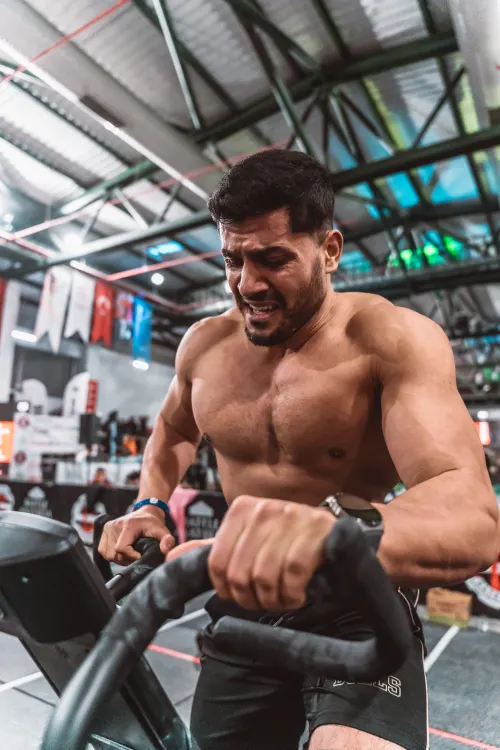 Athlete pedaling a stationary exercise bike in a gym