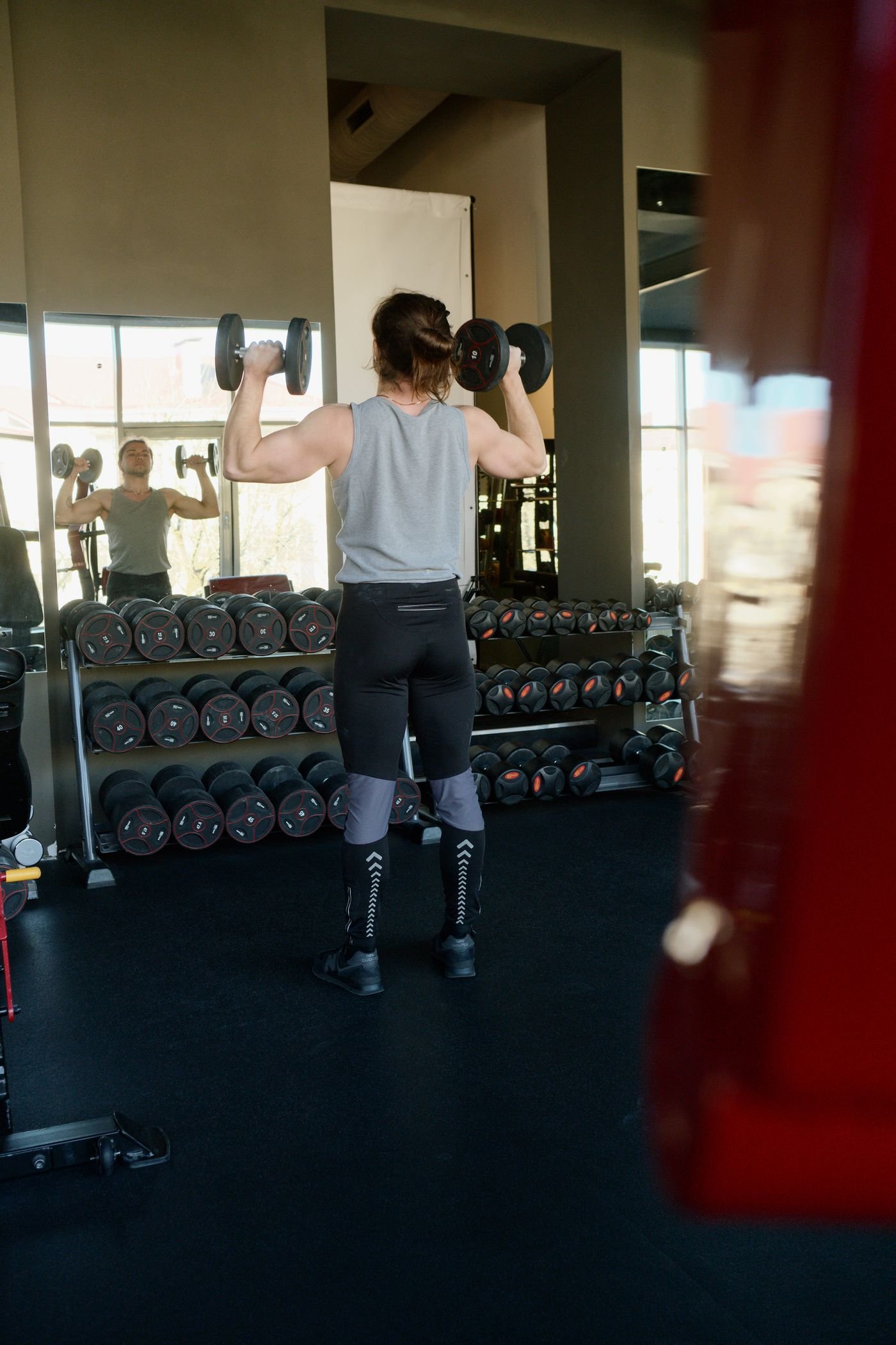Man lifting dumbbells in a weight-training gym