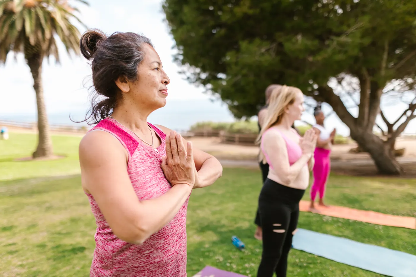 Older woman practicing balance and movement exercises in a park