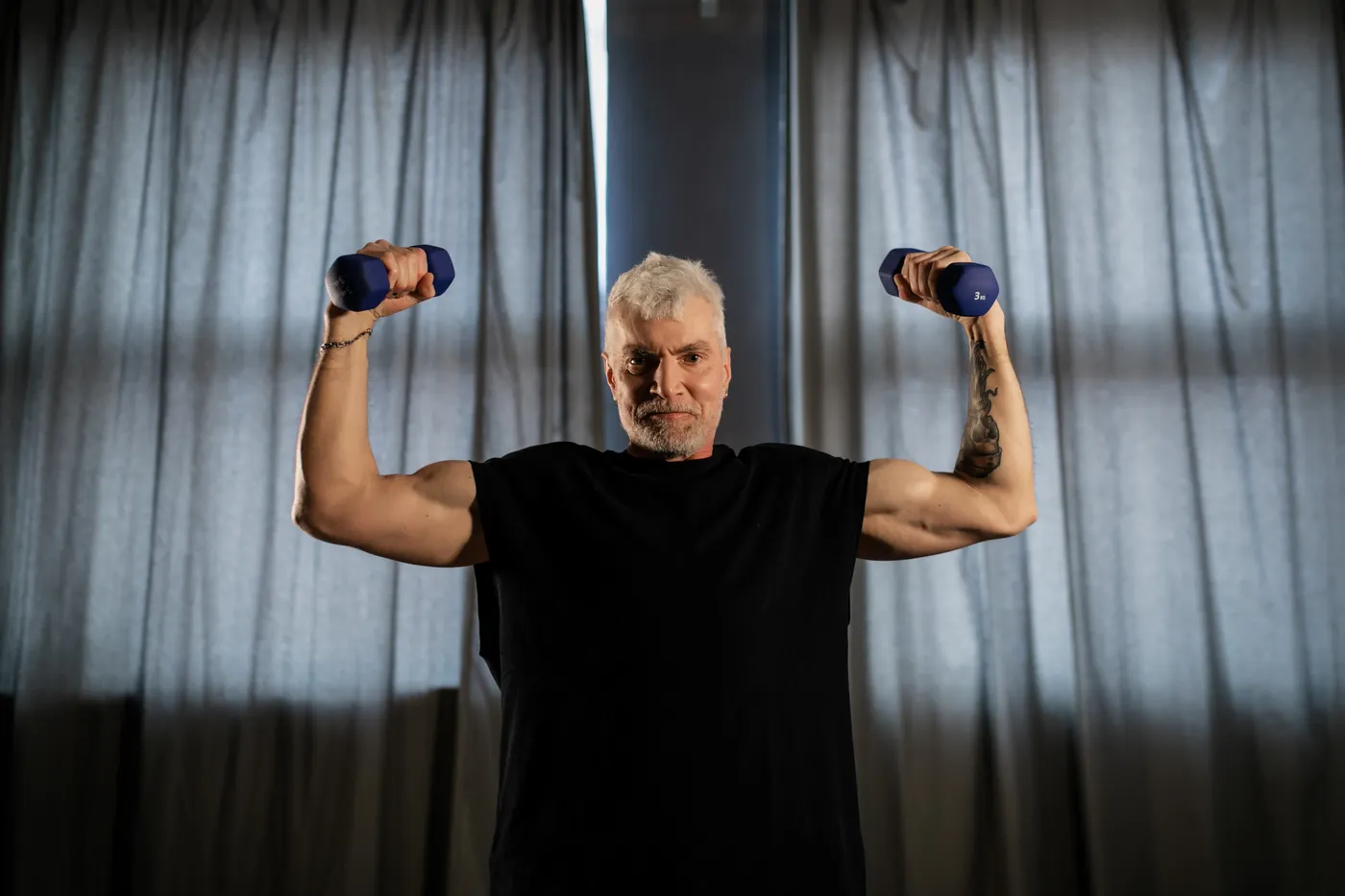 Older man practicing a controlled dumbbell strength exercise
