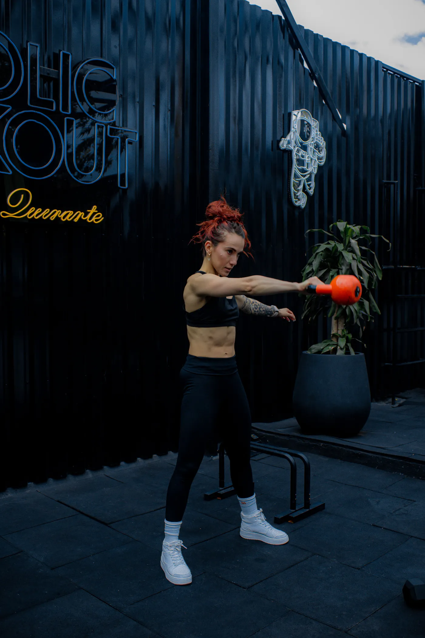 Athlete holding a kettlebell while training outdoors