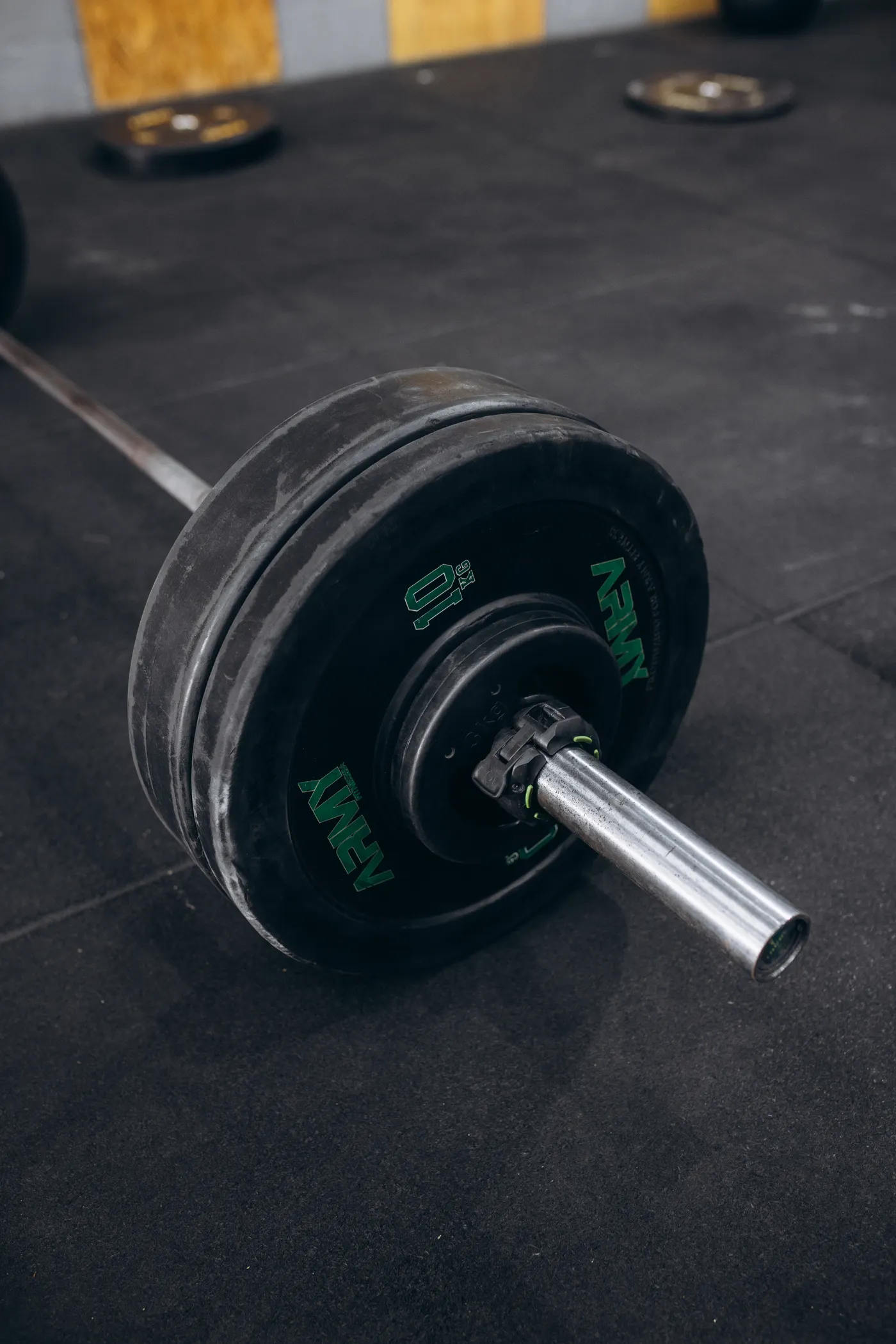 Loaded barbell with weight plates on a gym floor