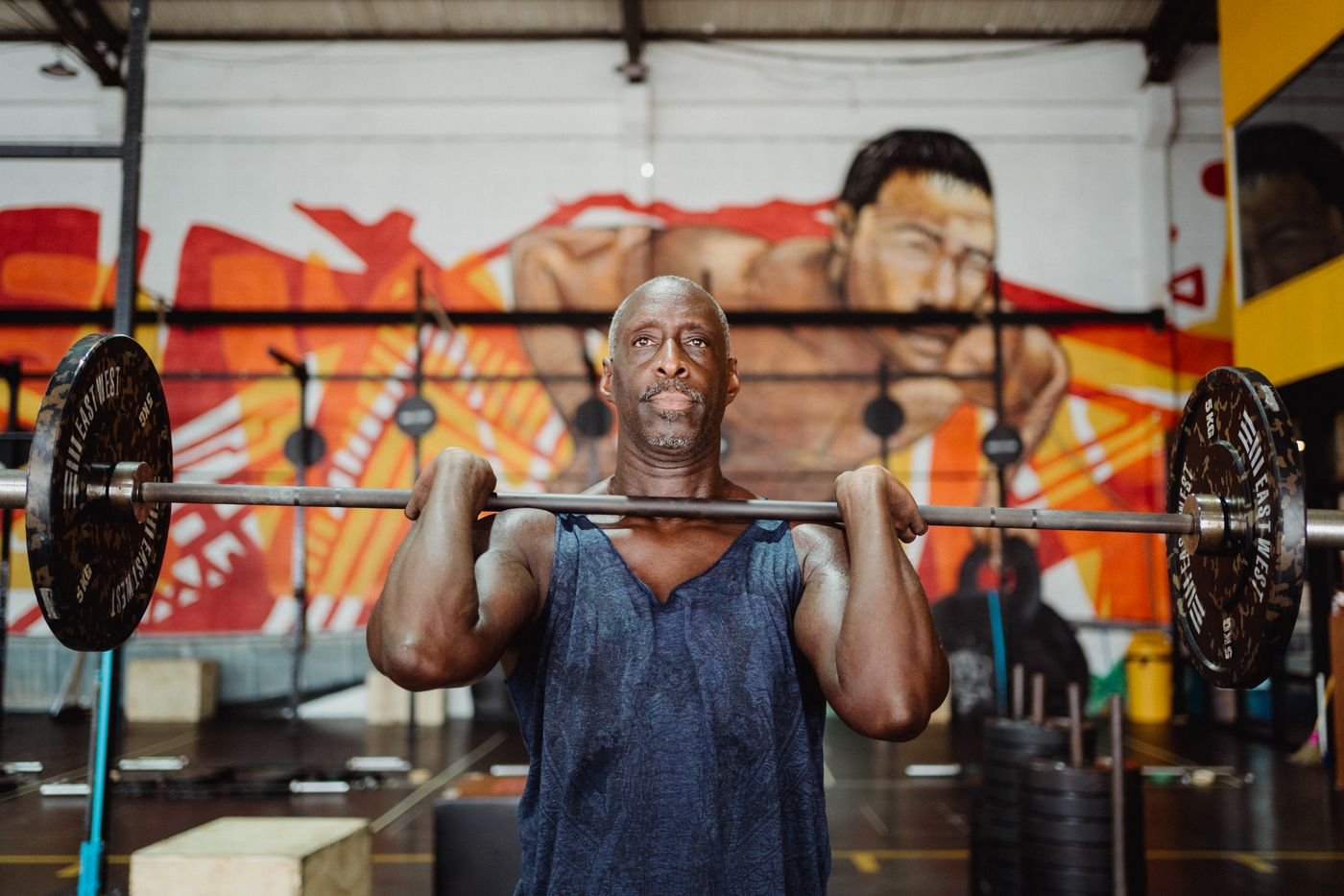 Man lifting a barbell during a demanding strength-training set