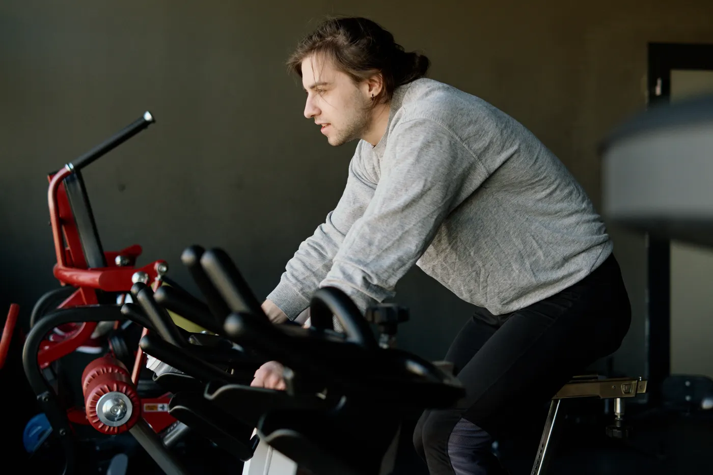 Man cycling on a stationary exercise bike in a fitness center
