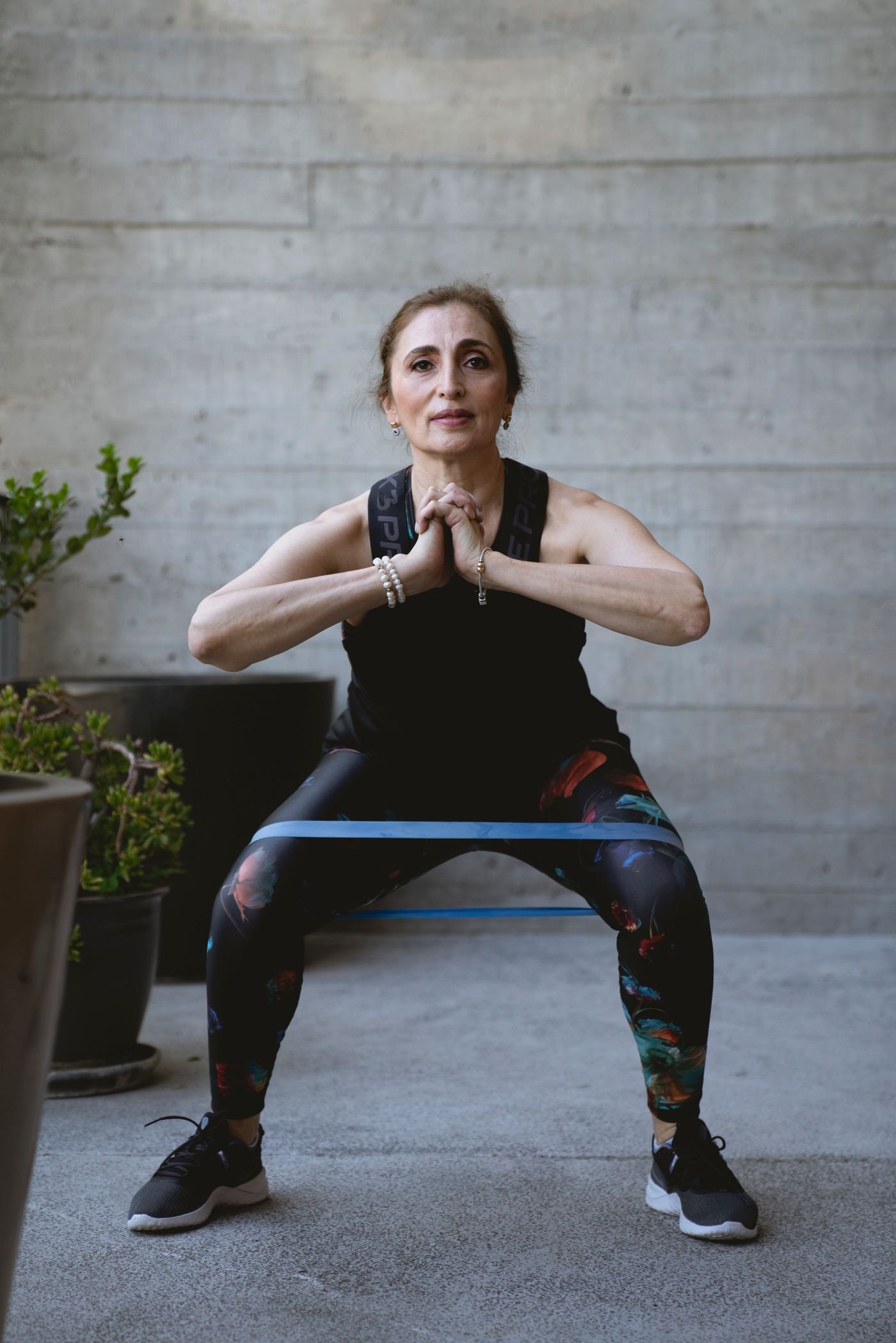 Older woman performing a controlled squat exercise