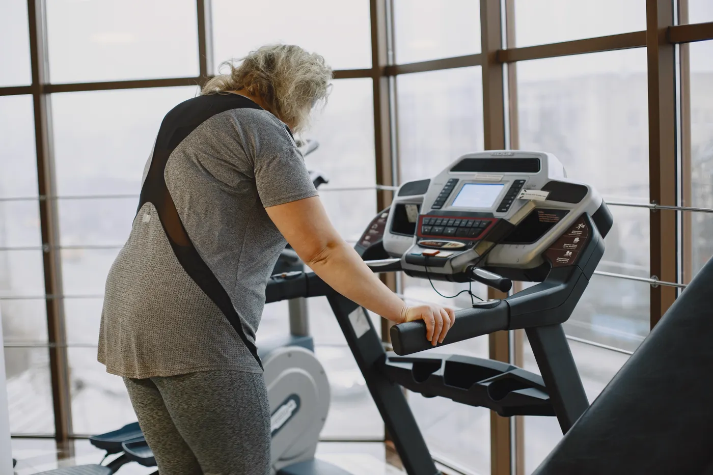 Senior woman walking on a treadmill during a fitness session