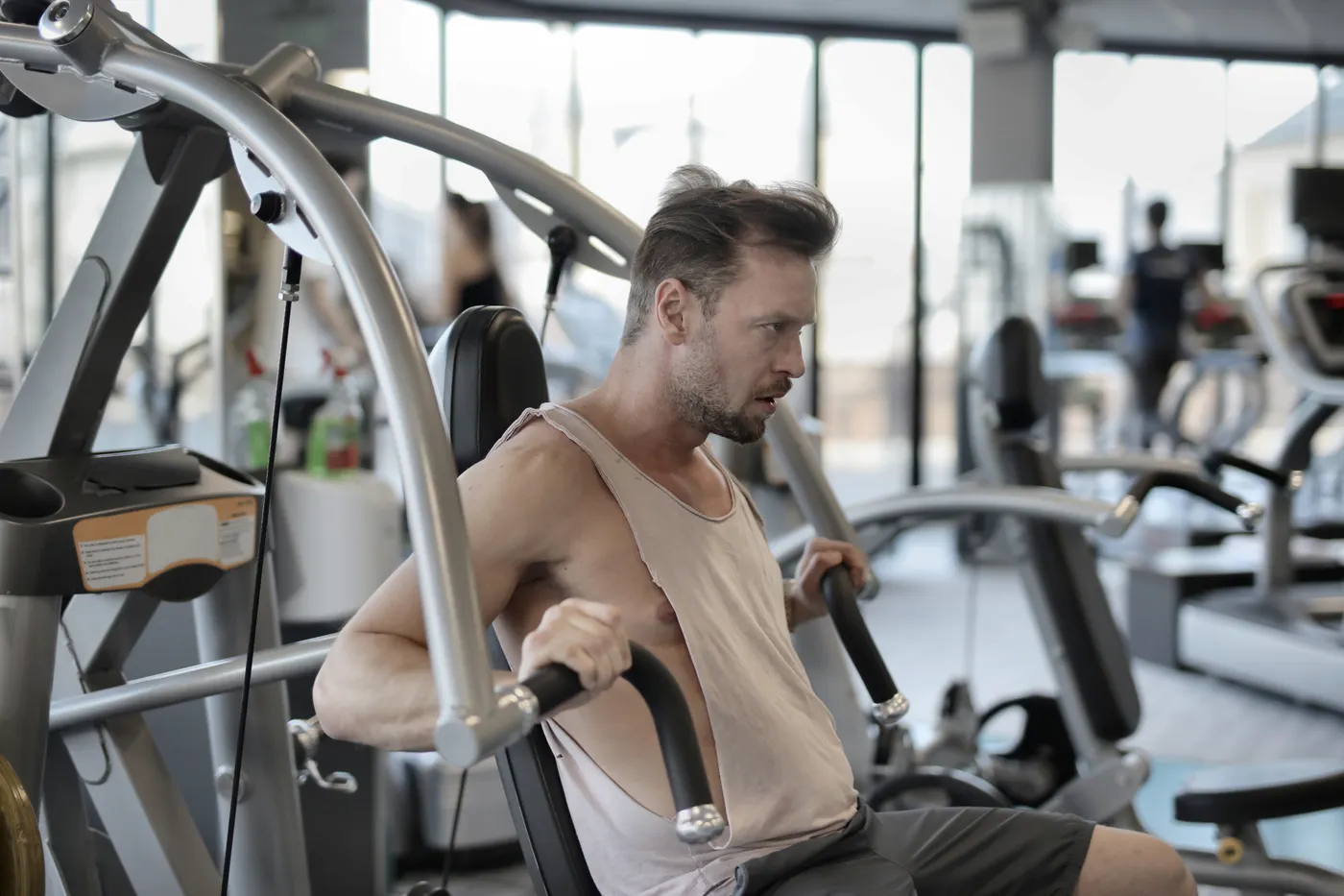 Man training with a seated shoulder press machine