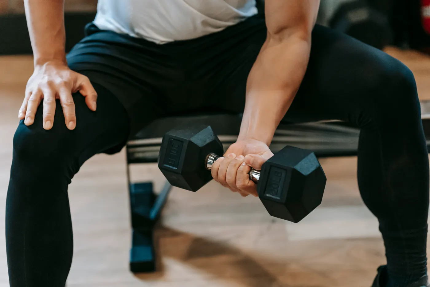 Close-up of an arm lifting a dumbbell in the gym