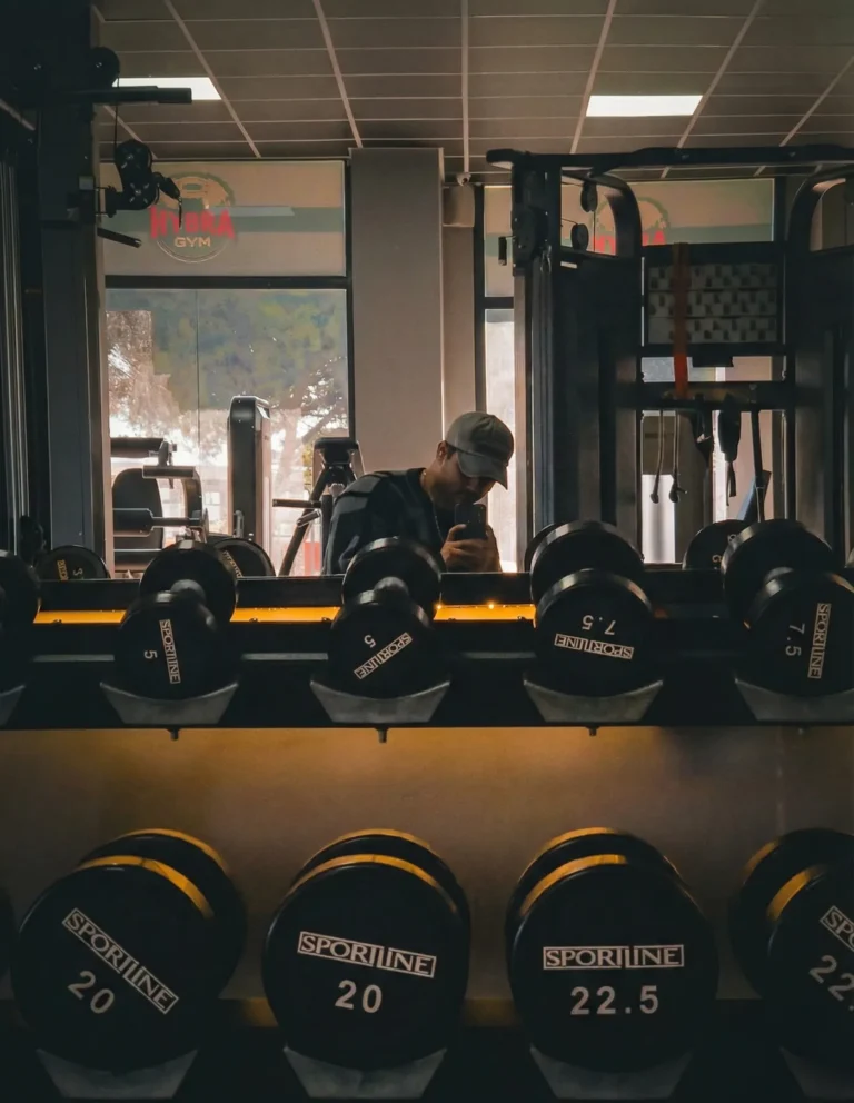Man lifting weights in a modern gym during a strength workout