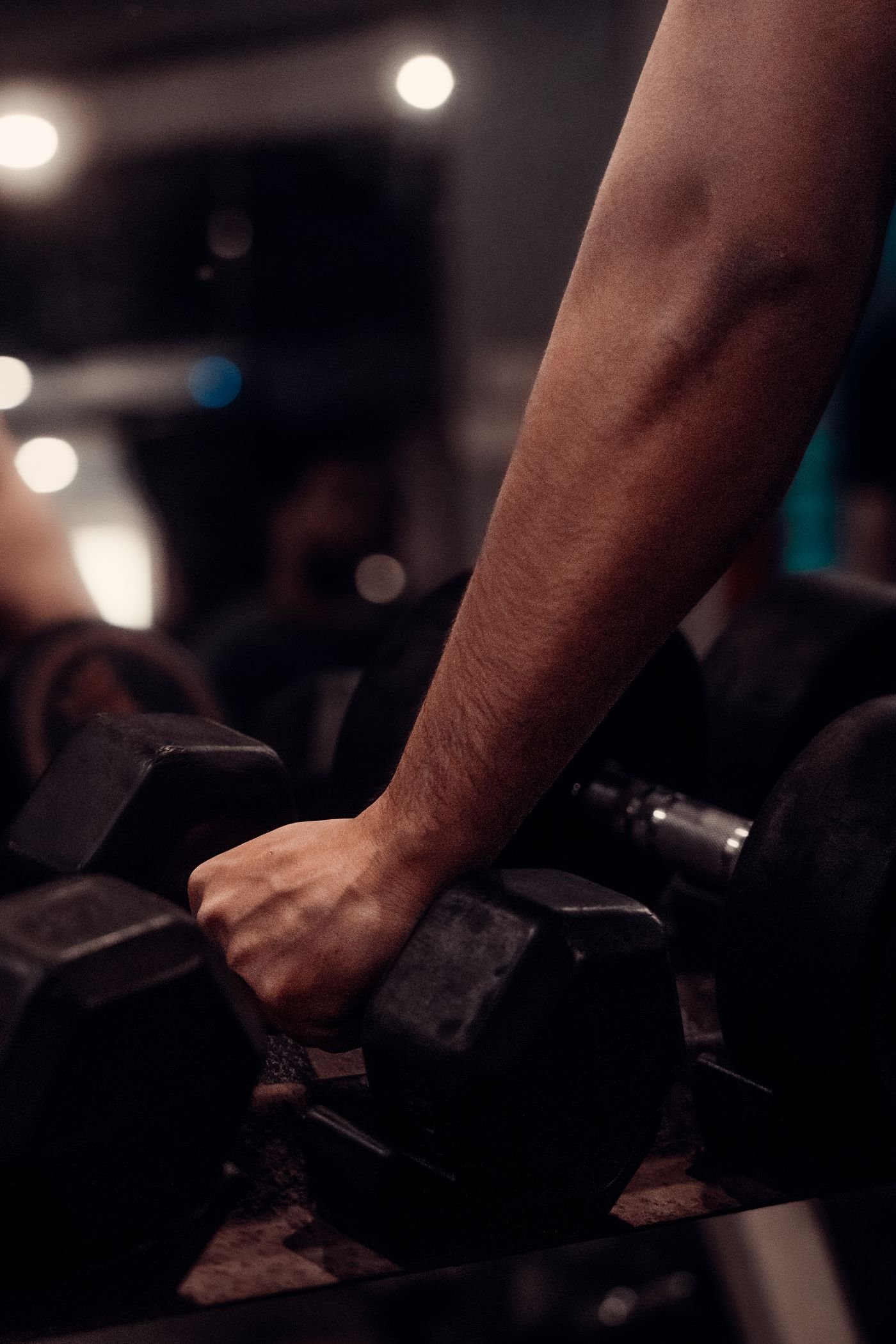 Close-up of a hand gripping a dumbbell during resistance exercise