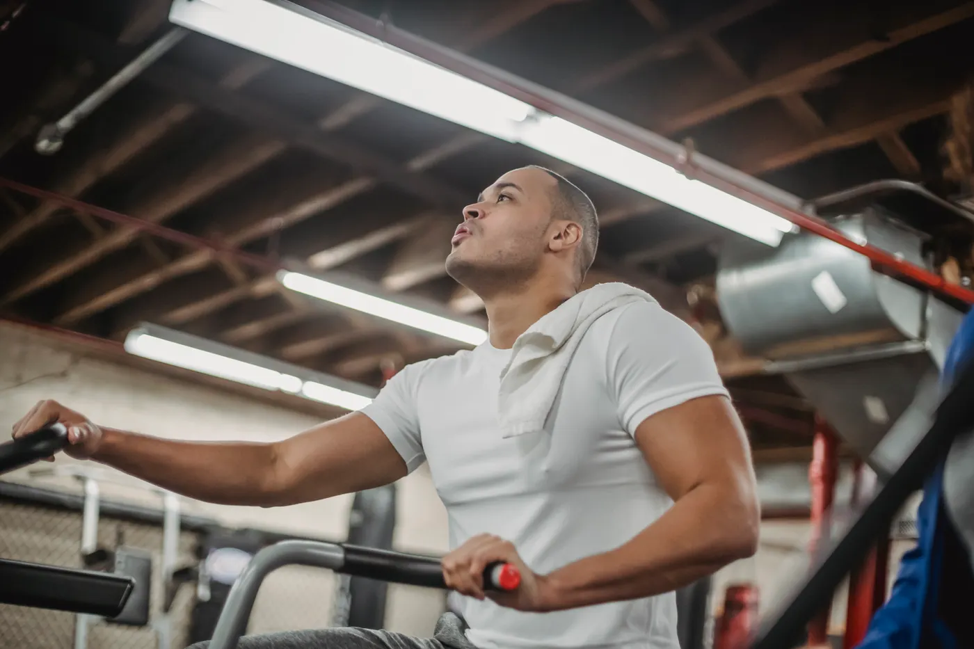 Athlete pedaling a stationary bike in a gym