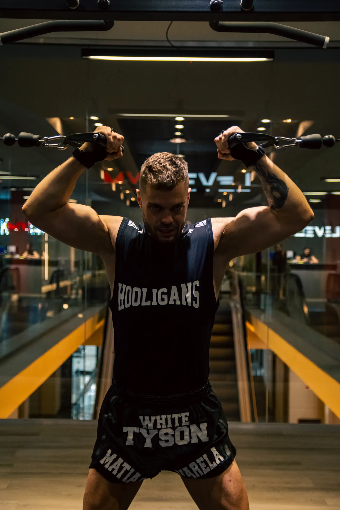 Man training on strength equipment in a modern gym