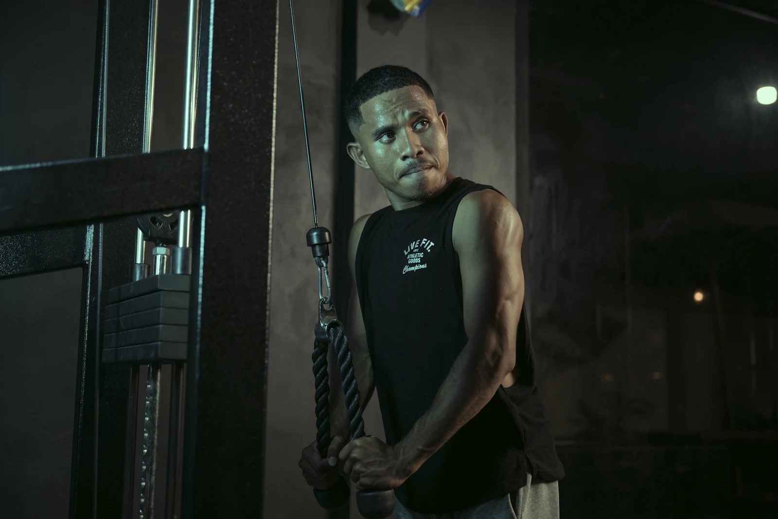 Lifter performing triceps-focused exercise in a gym
