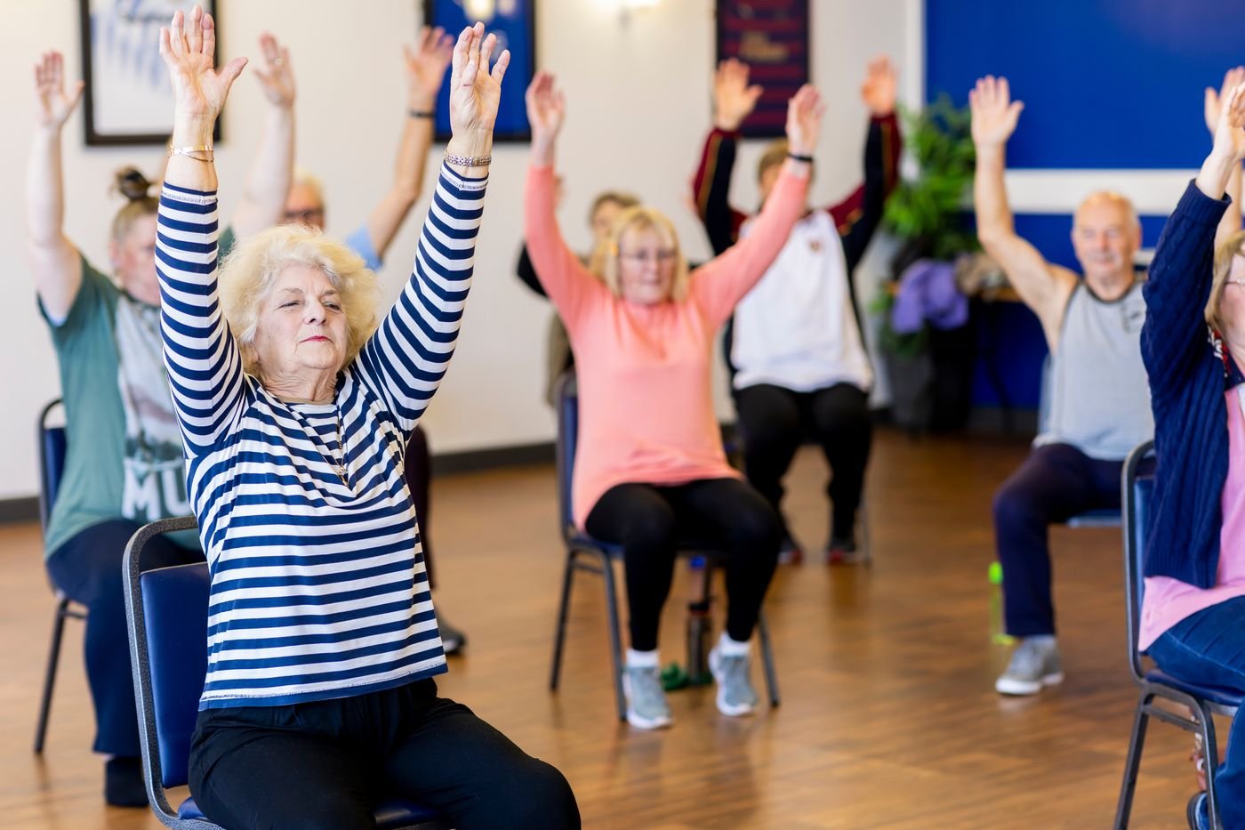 Older adults taking part in a chair-based exercise class