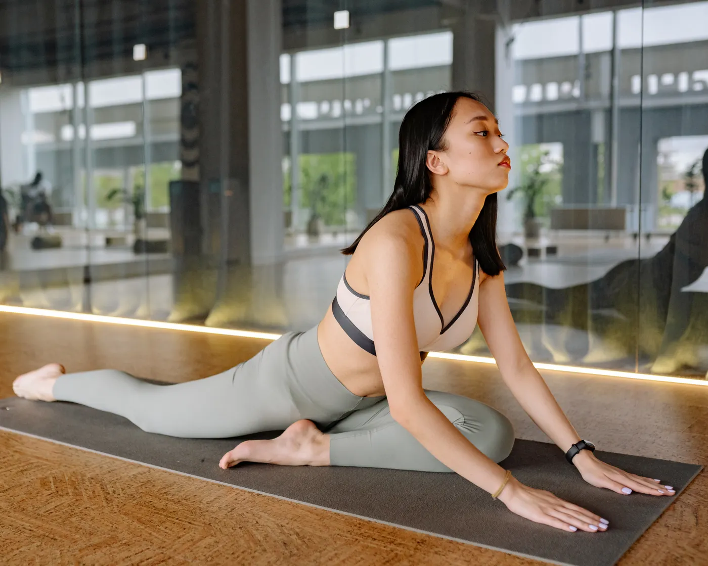 Woman practicing a hip mobility stretch on an exercise mat